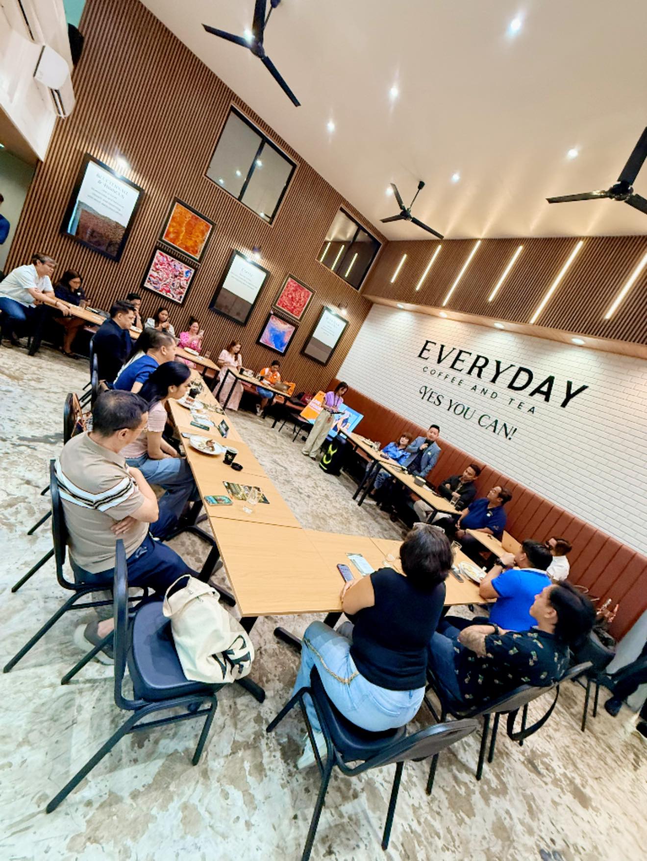 Members deep in discussion at Everyday Coffee and Tea